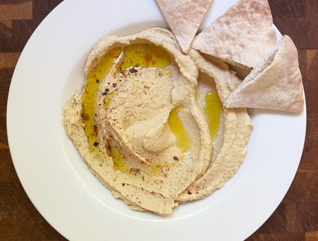 This homemade hummus recipe is super simple to make: throw everything into a blender and blend it up until smooth!